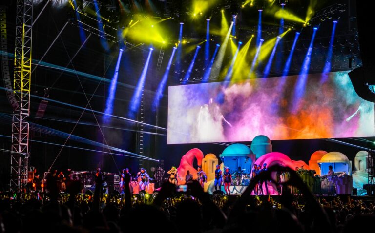 Energetic concert scene with colorful lights and performers on stage